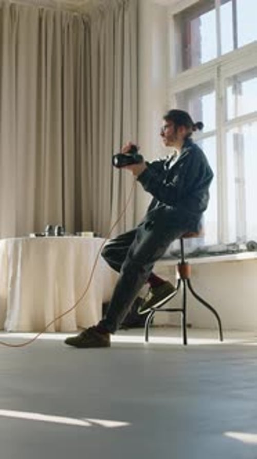 Studio Photographer Working with Camera Indoors