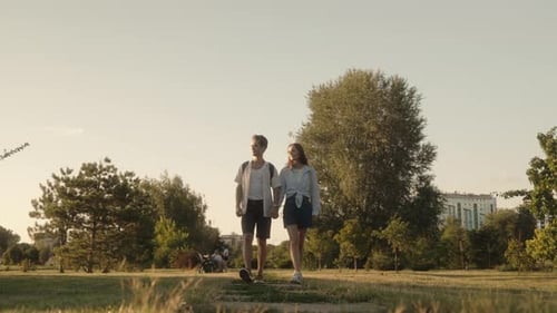 Couple Holding Hands Walking In Park