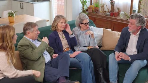 Friends Talk Together on Couch in Living Room