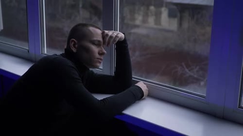 Young Man Looking Window