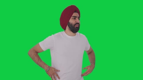 Sick Sikh Indian man suffering from stomach pain Green screen