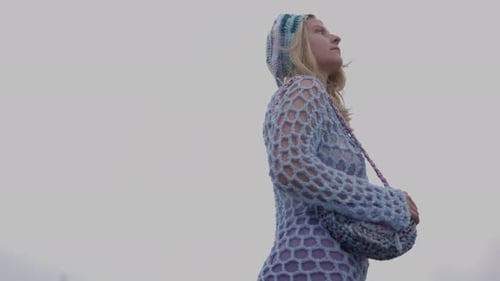 Stylish Young Woman Walking Outside on Windy Day