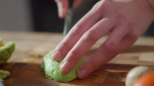 Close up of Cutting Slices of Avocado on Board