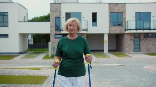 Active Senior Woman Engaging in Exercise Activities Outdoors Using Nordic Walking Poles