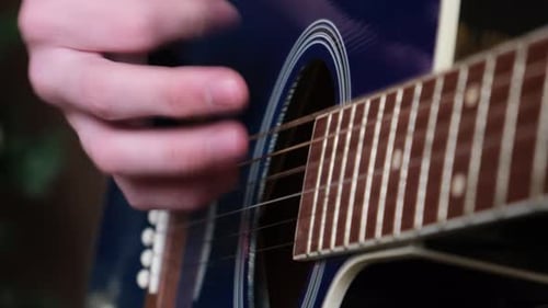 Closeup of Learning to Play the Acoustic Guitar