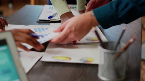 Team Hands Reviewing Business Charts