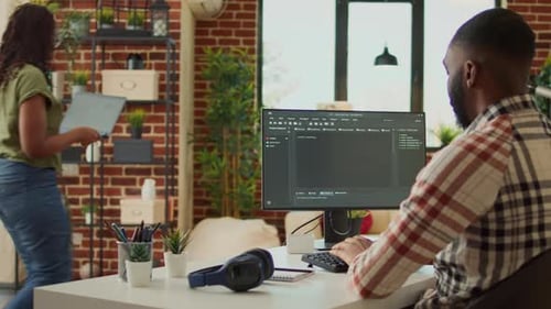 Man Typing on Computer in Modern Living Room