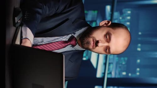 Man Working at Computer in Office at Night