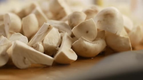 Fresh Champignons Mushroom on a Chopping Board