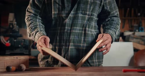Woodworker Bending Wood in Workshop