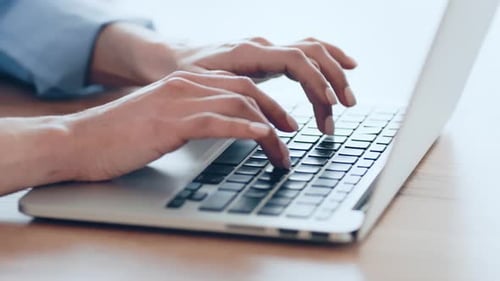 Hands Typing on Silver Laptop Computer Keyboard