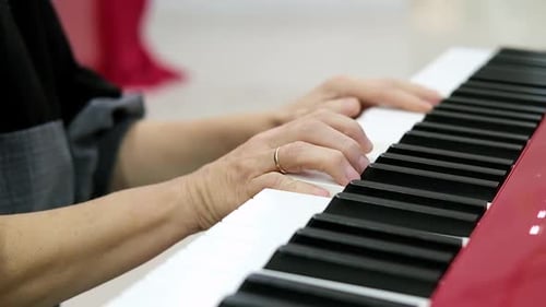 Woman Plays Piano Keyboard Close Up in Home