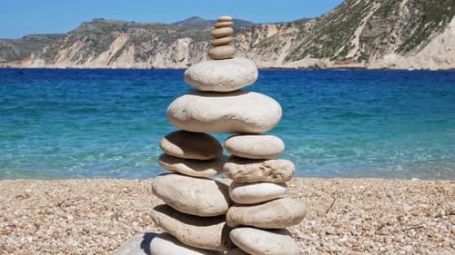 Stones pebbles stacks on beach coast in Agia Kiriaki, Milos island, Greece - Concept of balance and