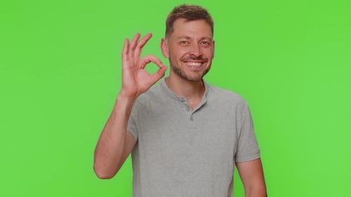 Man Gives Okay Sign on Green Screen