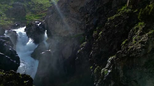 Waterfall flowing next to rocks in the forest