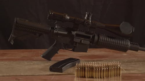 Rifle with Ammunition on a Wooden Table