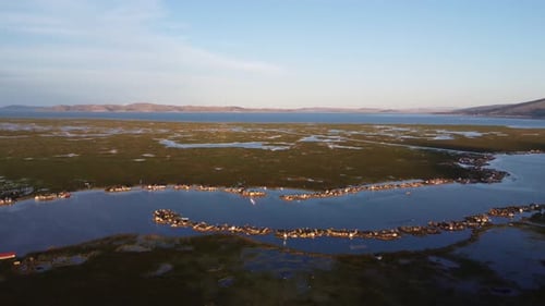 Drone shot of floating villages on Lake Titicaca in Peru.