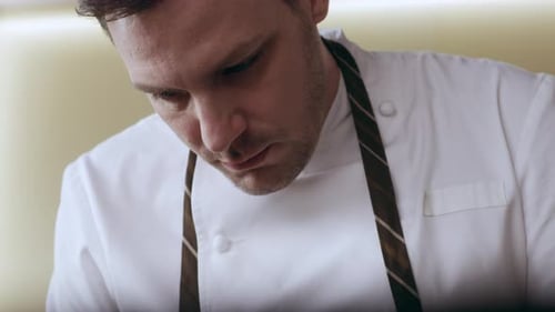 Chef Plates Delicate Dish in Restaurant Kitchen