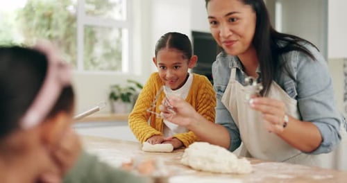 Mother and Daughter Baking Together in Kitchen