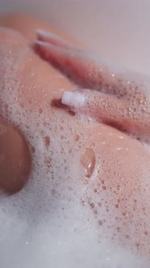 Woman Applies Foam on Legs Taking in Bathtub