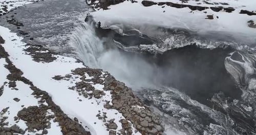 Behold the magnificent Dettifoss Waterfall in Iceland, showcasing a magnificent black mountain adorn