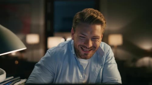 Young Adult Working at Laptop at Night