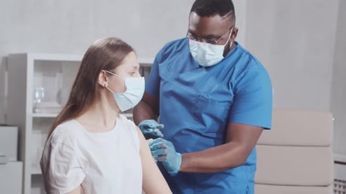Nurse Giving Injection to Patient in Clinic