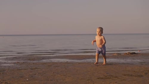 Child Toddles on Beach at Sunrise