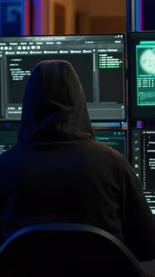 Person Coding in Dark Room at Computer