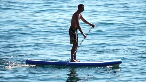 Man Sup Sea Strong Athletic Man Learns to Paddle Sup Standing on Board in Open Sea Ocean on Sunny
