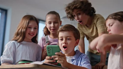 Excited Children Watching Smartphone Video Together