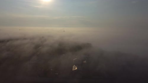 City Buildings Under Ethereal Fog Aerial Shot