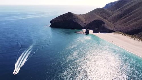 Drone aerial view of seashore, coastline, scenic view of people at unspoiled beach