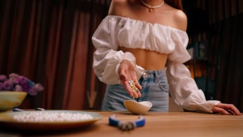 close-up female hands pouring out beautiful beads for a necklace or earrings the beauty of jewelry