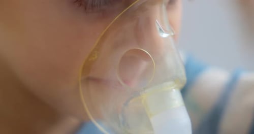 Child Using Nebulizer Mask for Respiratory Treatment