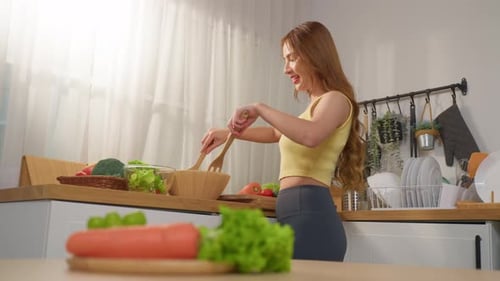 Woman Preparing Fresh Vegetable Salad in Kitchen