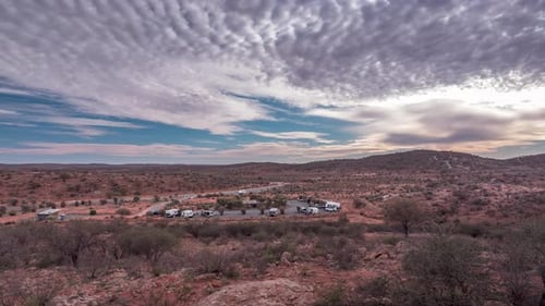 Time-lapse of gloomy clouds racing across the sky above a lonely campsite outside of Broken Hill in