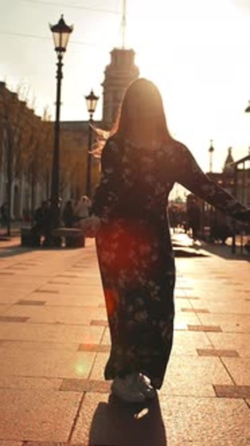 Vertical of Happy Cute Girl Jumping Outdoor at City Streets