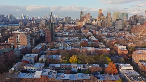 Aerial View of Low Rise Residential Buildings and Colorful Autumn Trees in Brooklyn with Manhattan