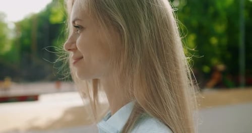 Blonde Woman Smiling in Urban Setting