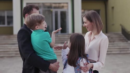 A Cheerful Family Gathers at a School Sharing Smiles and Laughter