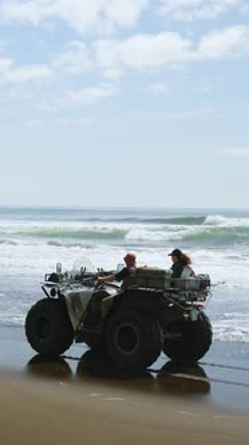 Two Adventurers Explore the Stunning Seaside While Riding an Allterrain Vehicle Along the Sandy