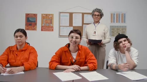 Women as Inmates Smiling at Camera with Female Teacher during Class in Prison