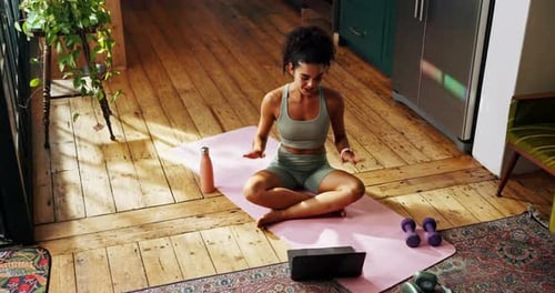 Young Woman Exercising at Home with Tablet