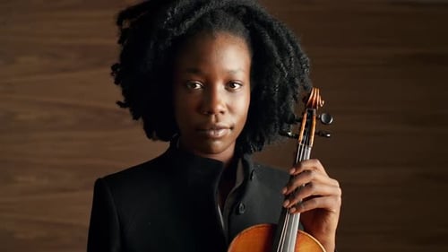 Young Woman Holding a Violin in a Close Up