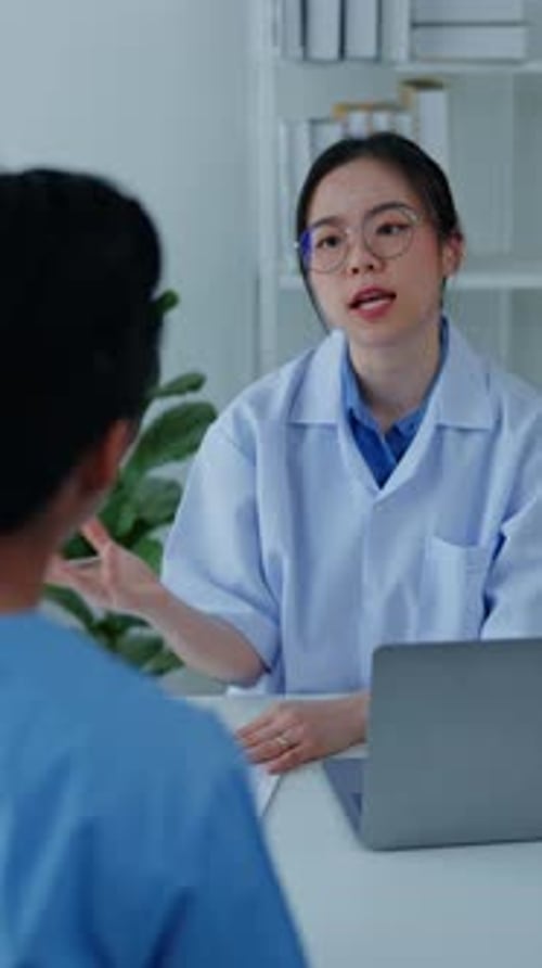 Vertical footage of Doctor examining patient in hospital.