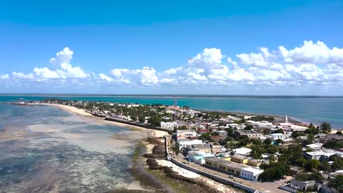 Aerial view of coastal town with white buildings, Mozambique.