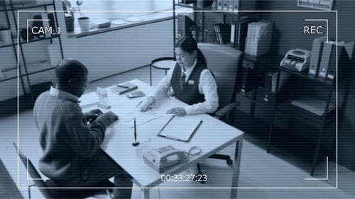 CAM View of Bank Employee Helping Elderly Customer in office