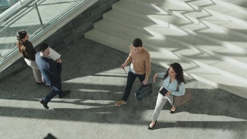 Business People Walking in Office Corridor