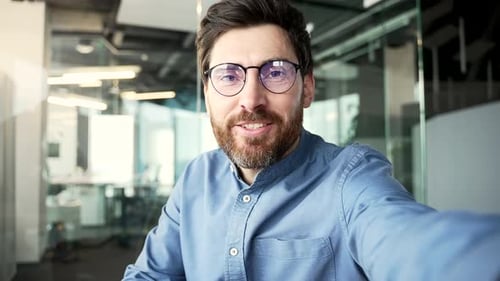 Cheerful Man Waving In Office Setting